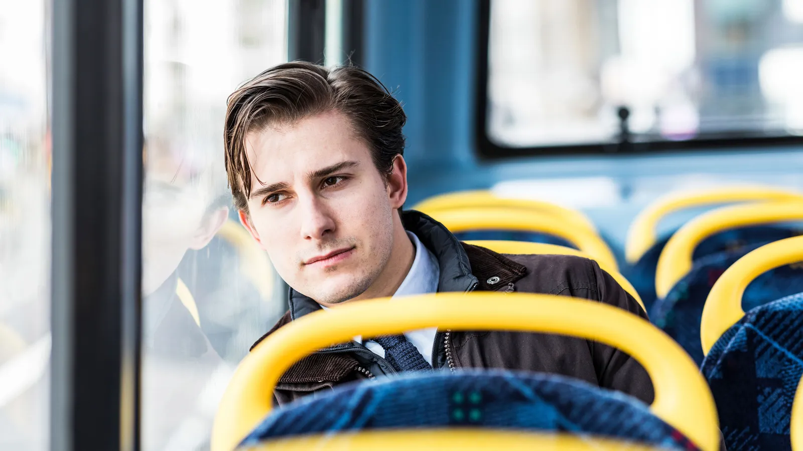 A man on a bus, sitting still and looking out the window, used here to stand for the moment of trying to read what an internal signal is actually telling you.