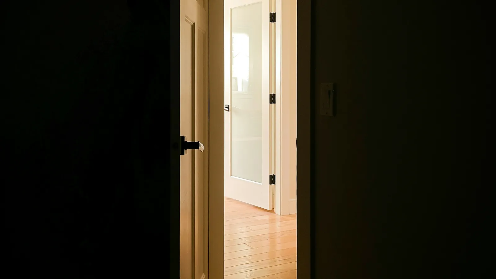 An open doorway with soft natural light beyond, used to symbolise the gentle progression of growing the comfort zone one small step at a time.